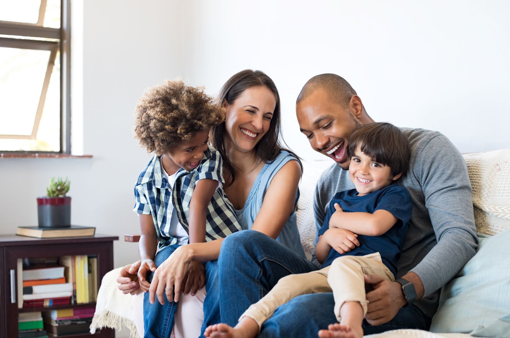 Family smiling sitting on a couch